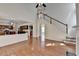 Open concept view of the living room staircase with hardwood floors that go into the kitchen at 580 Hammersmith Dr, Suwanee, GA 30024