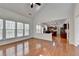 Open-concept living space with vaulted ceiling, hardwood floors, and view into the kitchen at 580 Hammersmith Dr, Suwanee, GA 30024