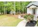 Landscaped backyard with a lovely patio, mature trees, and lush lawn at 909 Otter Ne Way, Marietta, GA 30068