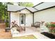 Charming patio area with outdoor seating, and a view of the lovely backyard at 909 Otter Ne Way, Marietta, GA 30068