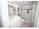 A stylish bathroom includes a white vanity, marble countertops, and a tiled shower at 909 Otter Ne Way, Marietta, GA 30068