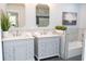 Elegant bathroom featuring double vanities with marble countertops, framed mirrors, and modern fixtures at 909 Otter Ne Way, Marietta, GA 30068
