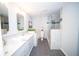 Contemporary bathroom with dual sinks, marble countertops, and a glass-enclosed shower at 909 Otter Ne Way, Marietta, GA 30068