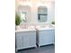 Elegant bathroom featuring double vanities with marble countertops, framed mirrors, and modern fixtures at 909 Otter Ne Way, Marietta, GA 30068