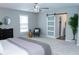 Serene bedroom with plush carpet, decorative ceiling fan, barn door to closet, and modern furnishings at 909 Otter Ne Way, Marietta, GA 30068