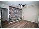 Charming bedroom features a modern ceiling fan and stylish accent wall with motivational art, plus wood-look flooring at 909 Otter Ne Way, Marietta, GA 30068