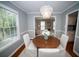 Elegant dining room with a crystal chandelier, hardwood floors, and natural light at 909 Otter Ne Way, Marietta, GA 30068