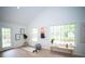 Bright exercise room featuring a high ceiling, large windows, and neutral decor at 909 Otter Ne Way, Marietta, GA 30068