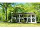 Charming two-story white home featuring a black roof, black shutters and a beautiful lawn at 909 Otter Ne Way, Marietta, GA 30068