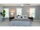 Spacious main bedroom with three large windows, neutral decor, plush carpet, and decorative ceiling fan at 909 Otter Ne Way, Marietta, GA 30068