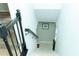 Carpeted staircase with decorative wrought iron railing leading to the lower level of the home at 909 Otter Ne Way, Marietta, GA 30068