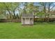 Cozy backyard shed with double doors, providing ample storage or potential for a hobby space at 2470 Woodmere Dr, Marietta, GA 30068