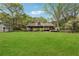 Large backyard with a well-maintained lawn, deck, shed, and an expansive grassy area at 2470 Woodmere Dr, Marietta, GA 30068