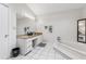 Bright bathroom featuring a large mirror, granite countertop vanity, and a pristine white soaking tub at 2470 Woodmere Dr, Marietta, GA 30068