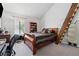 Bedroom with dark wood furniture, a mounted ironing board, and a view of the outdoors at 2470 Woodmere Dr, Marietta, GA 30068