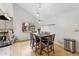 Bright dining area with a modern table set, stylish light fixture, and views of the landscaped yard at 2470 Woodmere Dr, Marietta, GA 30068