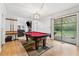 Game room with pool table, hardwood floors, and sliding glass doors to the outdoor deck at 2470 Woodmere Dr, Marietta, GA 30068