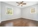 Sunlit bedroom features hardwood floors, neutral walls, and windows showcasing exterior greenery at 2804 Carolyn Se Dr, Smyrna, GA 30080