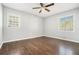 Bright bedroom featuring hardwood floors, ceiling fan, and natural light from two windows at 2804 Carolyn Se Dr, Smyrna, GA 30080