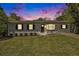 Charming single-story home boasts a well-manicured lawn and fresh exterior paint at twilight at 2804 Carolyn Se Dr, Smyrna, GA 30080