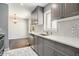 Modern kitchen with stainless steel appliances, gray cabinets, and white subway tile backsplash at 2804 Carolyn Se Dr, Smyrna, GA 30080
