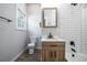Modern bathroom featuring a white subway tile shower and a wood vanity with black hardware at 754 Fayetteville Se Rd, Atlanta, GA 30316