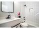 Modern bathroom featuring subway tile tub, vanity and black fixtures at 754 Fayetteville Se Rd, Atlanta, GA 30316