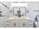 Contemporary bathroom with dual vanity, matte black fixtures, and tub with shower and white tile at 754 Fayetteville Se Rd, Atlanta, GA 30316