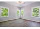Bright bedroom featuring hardwood floors and an abundance of natural light from the surrounding greenery at 754 Fayetteville Se Rd, Atlanta, GA 30316