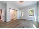 Bedroom with hardwood floors, closet with sliding barn door, and two windows at 754 Fayetteville Se Rd, Atlanta, GA 30316