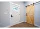 Stylish entryway featuring a modern front door and sliding barn door, creating a welcoming and functional space at 754 Fayetteville Se Rd, Atlanta, GA 30316