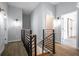 Bright hallway with modern railing, hardwood floors, and stylish lighting fixtures throughout the upper level at 754 Fayetteville Se Rd, Atlanta, GA 30316