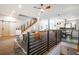 Open-concept living room with wood floors, modern staircase, and view of the kitchen at 754 Fayetteville Se Rd, Atlanta, GA 30316