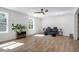 Well lit living room featuring hardwood floors, neutral paint, and a stylish ceiling fan at 754 Fayetteville Se Rd, Atlanta, GA 30316