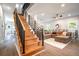 Open-concept living space featuring hardwood floors, modern staircase and neutral color scheme, perfect for relaxation at 754 Fayetteville Se Rd, Atlanta, GA 30316