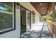 Inviting covered porch with gray tile floors, modern lighting, and a view into the home's interior at 754 Fayetteville Se Rd, Atlanta, GA 30316