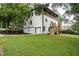 A rear view of the house featuring a backyard with a covered deck and stairs, perfect for outdoor entertaining at 754 Fayetteville Se Rd, Atlanta, GA 30316