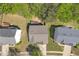 Aerial view of home and yard with green lawn surrounded by other houses and mature trees at 818 Prada Ct, Lawrenceville, GA 30043