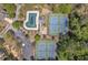 Overhead view of community amenities featuring tennis courts, pool, playground, parking, and green space at 818 Prada Ct, Lawrenceville, GA 30043