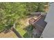 Aerial view of backyard featuring a wooden deck overlooking a lawn surrounded by privacy fence and trees at 818 Prada Ct, Lawrenceville, GA 30043