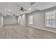Spacious basement featuring wood-look flooring, windows, and two ceiling fans at 818 Prada Ct, Lawrenceville, GA 30043