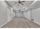 Large finished basement with wood-look flooring, ceiling fans, and recessed lighting at 818 Prada Ct, Lawrenceville, GA 30043