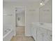 Bright bathroom featuring a soaking tub and double vanity at 818 Prada Ct, Lawrenceville, GA 30043