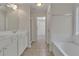 Bright bathroom featuring double sink vanity, a tub, and a walk-in shower at 818 Prada Ct, Lawrenceville, GA 30043