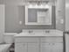 Bathroom featuring a double sink vanity, large mirror, and updated fixtures at 818 Prada Ct, Lawrenceville, GA 30043