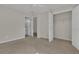 Neutral bedroom featuring carpeted floors, ceiling fan, walk-in closet, and ensuite bathroom access at 818 Prada Ct, Lawrenceville, GA 30043