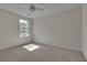 Bright bedroom featuring a ceiling fan, window, and neutral carpeting at 818 Prada Ct, Lawrenceville, GA 30043