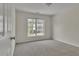 Cozy bedroom with neutral carpet and a bright window at 818 Prada Ct, Lawrenceville, GA 30043