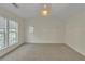 Bright, carpeted bedroom with three windows and vaulted ceilings for a spacious feel at 818 Prada Ct, Lawrenceville, GA 30043