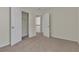 Bedroom featuring neutral carpet, paint and two closets, providing storage solutions at 818 Prada Ct, Lawrenceville, GA 30043